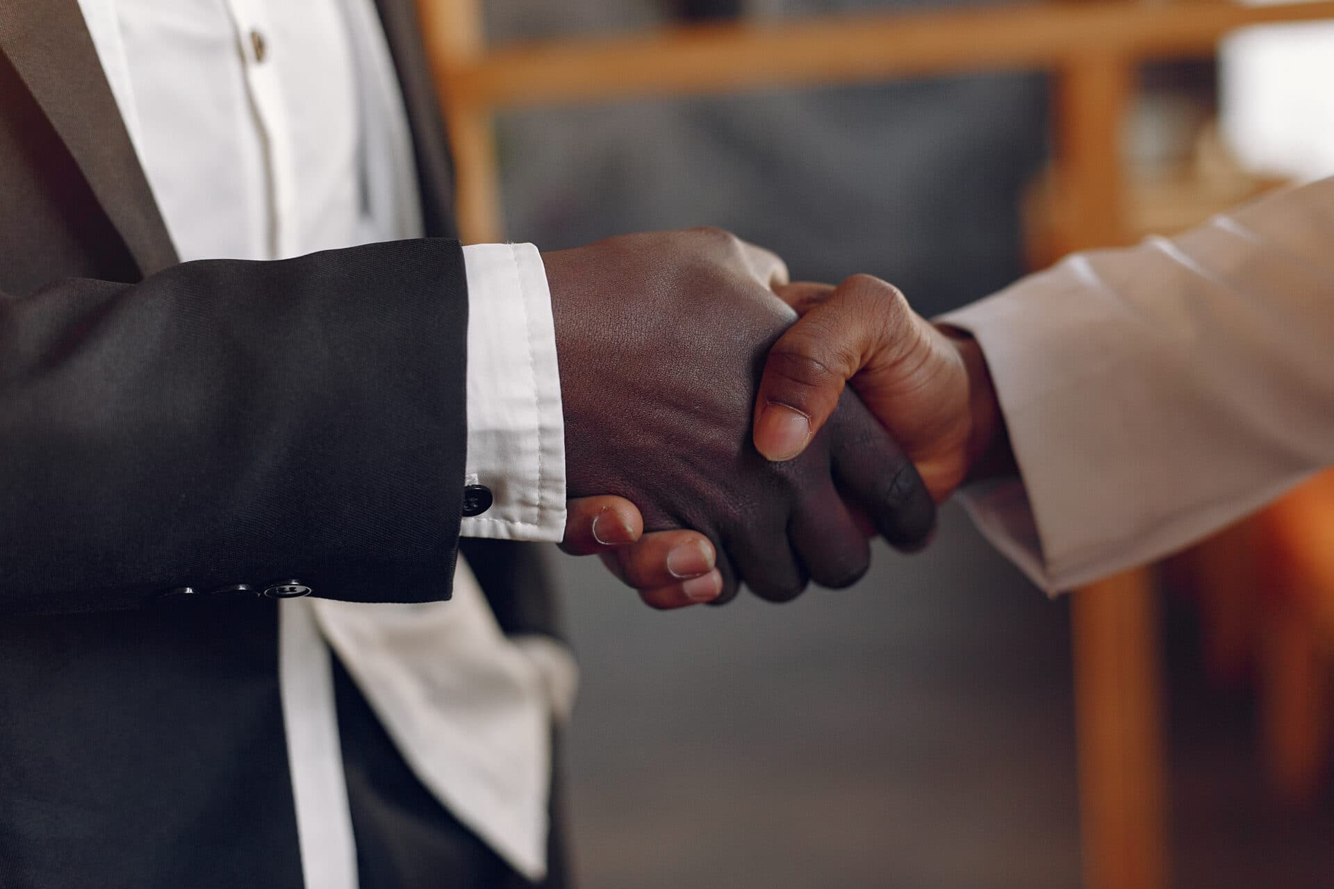 Black men in a cafe. Guy talking. Man in a black suit.