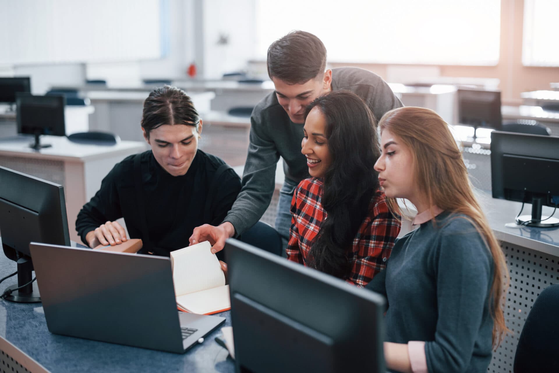 Group of young people in casual clothes working in the modern office